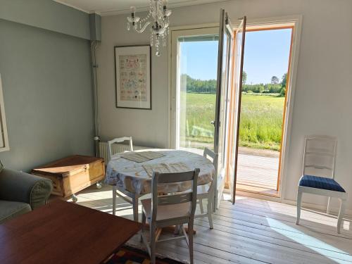 a living room with a table and chairs and a window at Rural charm & modern comfort 