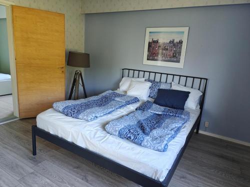 a bed with two pillows on it in a room at Rural charm & modern comfort 
