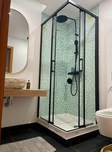 a bathroom with a shower with a glass enclosure at Apartment T3, sea view, swimming pool- Casa do Mar in Zambujeira do Mar