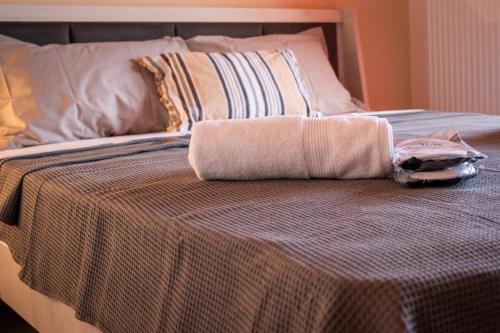 a bed with a towel on top of it at TONI HOuSE in Alexandroupoli