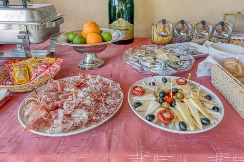 a table with three plates of food on it at Grad Inn Apartments & Resort in Gračišče