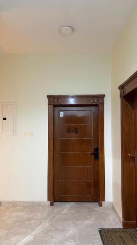 a large wooden door in the corner of a room at استديو جديد in Hail