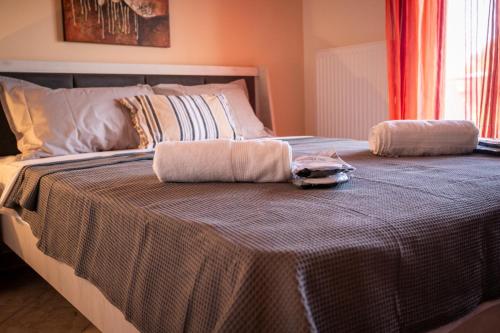 a bed with two towels on top of it at TONI HOuSE in Alexandroupoli