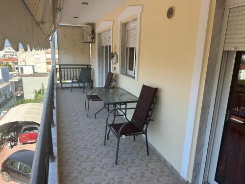 a patio with a table and chairs on a balcony at TONI HOuSE in Alexandroupoli