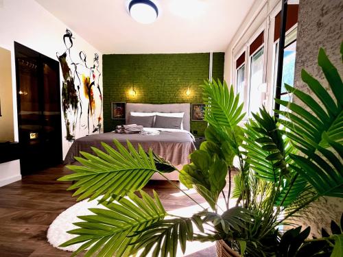 a bedroom with a bed and a green wall at Macedonia Square Suite 22 - Pedestrian Street in Skopje