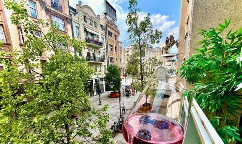 a glass vase sitting on a balcony in a city at Macedonia Square Suite 22 - Pedestrian Street in Skopje