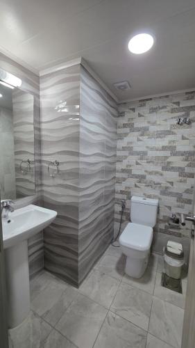a bathroom with a toilet and a sink at Chouf View Residence in Baddah