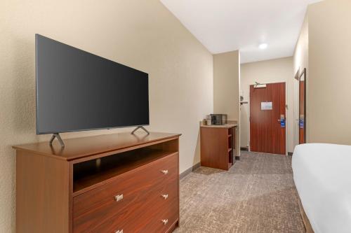 a large flat screen tv on a dresser in a hotel room at Comfort Inn & Suites Morgan - South Ogden in Morgan