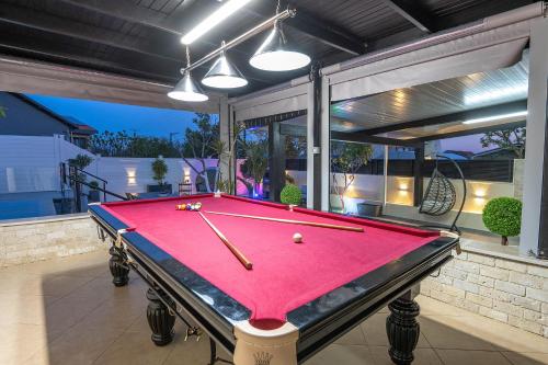 a pool table sitting on top of a patio at וילה פלואלס בוטיק in Shahar