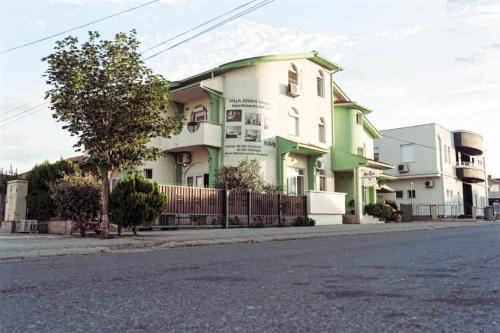a white and green building on the side of a street at Villa Jovan Gevgelija in Gevgelija