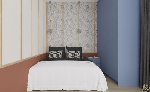 a bedroom with a white bed with two pillows at Jurowiecka 22 ORANGE Centrum Modern Apartment in Białystok