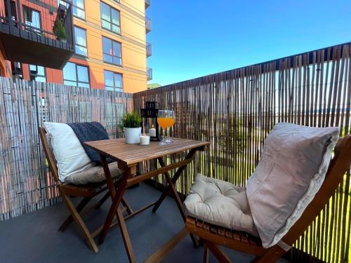 a balcony with a table and two chairs on a patio at City apartment Tallinn Free parking in Tallinn