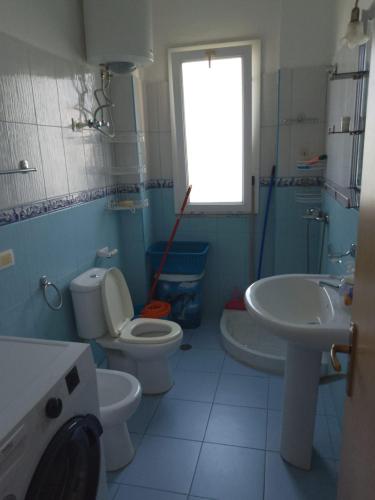 a bathroom with a toilet and a sink at Kujtim in Golem