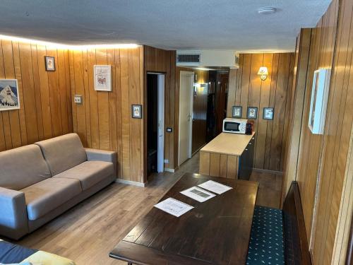 a living room with a couch and a table at Rododendro Ski-in Ski-out CIR 0491 in Breuil-Cervinia