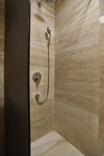 a shower with a shower head in a bathroom at Apartments Menuet in Budva
