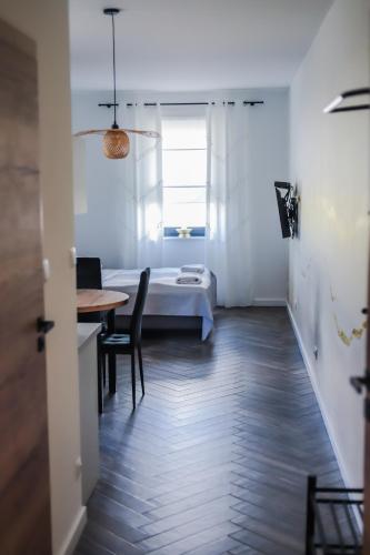 a small room with a bed and a table and chairs at Willa Jaworzynka 1103 K Istebnej in Jaworzynka