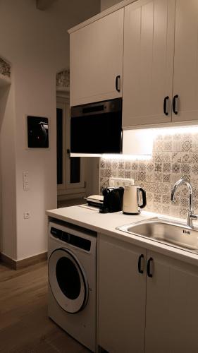 a kitchen with a sink and a stove top oven at Stilvi Milos in Plaka Milou