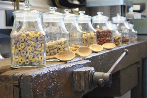 a group of glass jars filled with different types of nuts at Roby's Boutique Rooms - Luxury B&B in Catania