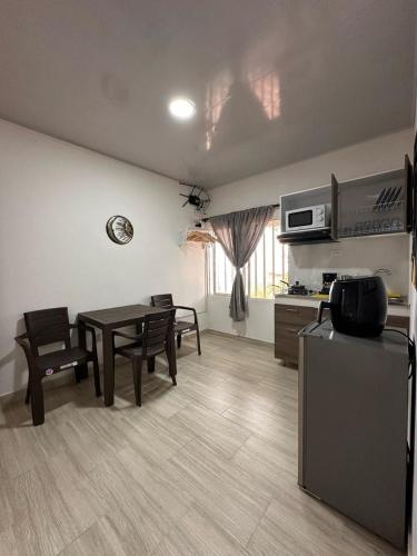 a kitchen and living room with a table and chairs at Apartaestudios Santa Ana in Ruiosucio