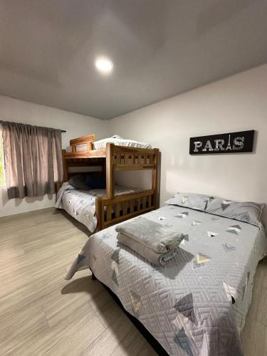 a bedroom with two beds and a bunk bed at Apartaestudios Santa Ana in Ruiosucio