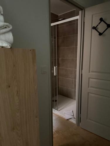 a bathroom with a shower and a glass door at Coccinelle in Aups