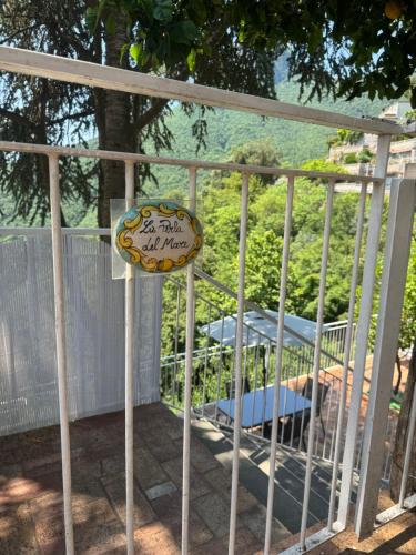 a gate with a sign on it with a bed at La Perla del Mare Apartment Vietri sul Mare in Albori