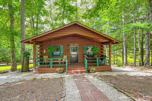 a wooden cabin in the woods with trees at 11 Mi to Dtwn Franklin Cabin with Porch! in Franklin