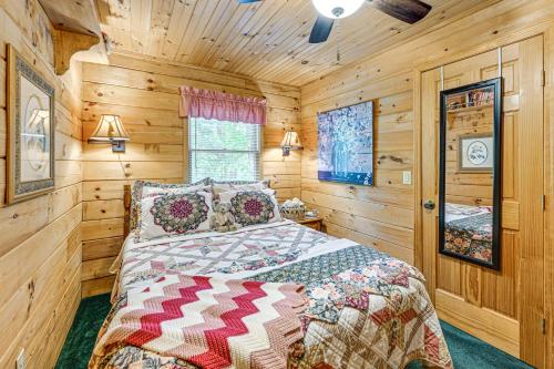 a bedroom with a bed in a wooden cabin at 11 Mi to Dtwn Franklin Cabin with Porch! in Franklin