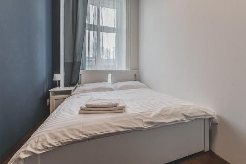 a bed with two towels on it in a room at Heart of Prague Lodgings 4 in Prague