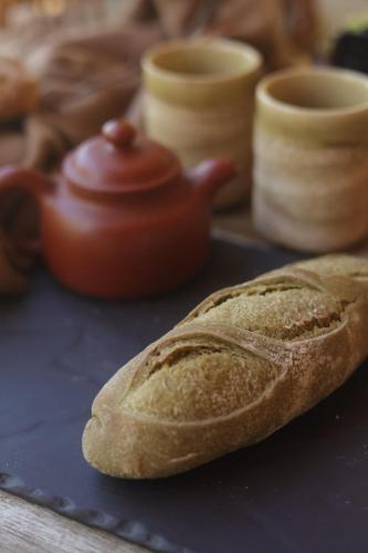 a loaf of bread sitting next to a teapot at SUNCHILL luxury treehouse in Saint-Antonin