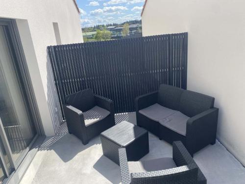 a balcony with two chairs and a couch and a table at Le Colinou Chambretaud - 5min du PUYDUFOU in Chambretaud