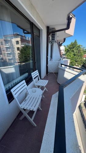 two chairs and a table on a balcony at FAMILY HOTEL SAINT PETER in St. St. Constantine and Helena