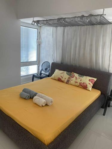 a bed with two towels on it in a bedroom at Soi's Apartment I in Olympic Beach