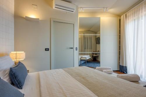 a bedroom with a large bed and a desk at Villa Clara Meloni in Motovun
