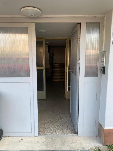 an open door of a building with a hallway at Apartman 'City View' Popovača in Popovača
