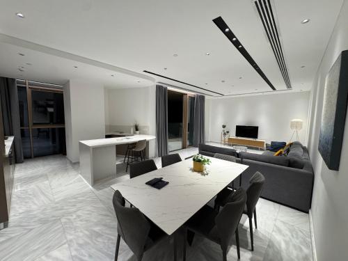 a living room with a table and a couch at SkyHigh Central 360 Gym & Pool in Nicosia