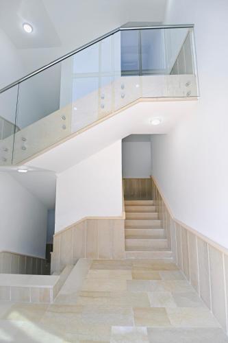 a staircase with glass railing in a building at Chouf View Residence in Baddah