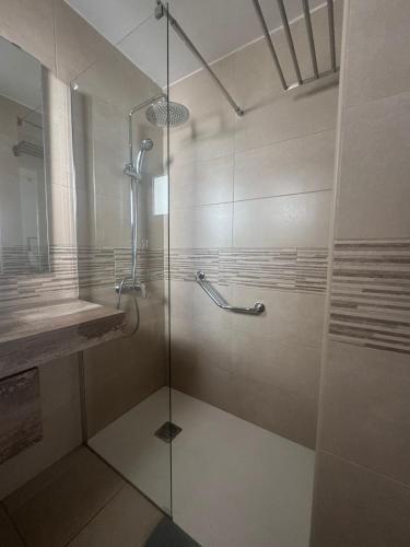 a shower with a glass door in a bathroom at Las Mimosas Beach Sol in Puerto del Carmen