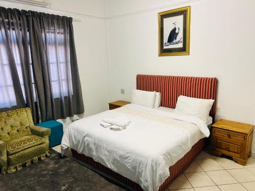 Postel nebo postele na pokoji v ubytování De-Villa Guesthouse