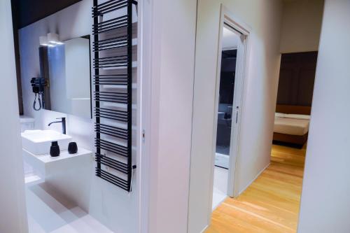 a bathroom with a sink and a mirror at Virginia Madre Luxury Rooms in San Benedetto del Tronto
