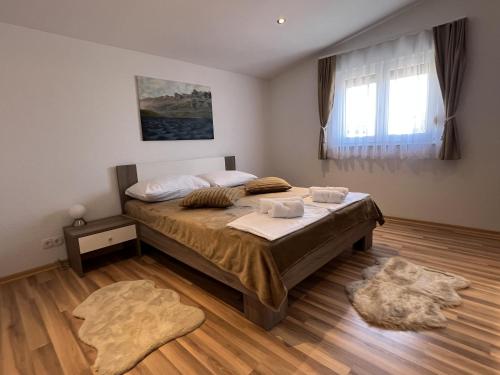 a bedroom with a large bed in a room at Villa Santolina in Maslenica