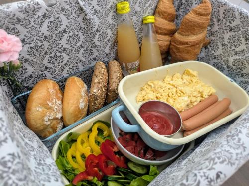a table topped with trays of food and bottles of milk at SB Apartment with Sauna in Kołobrzeg