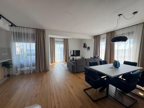 a living room with a table and a couch at HORIZON Privlaka3 in Privlaka