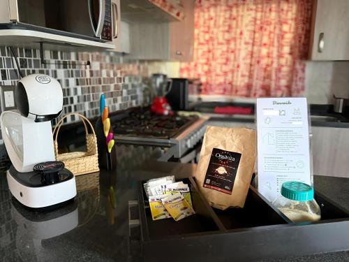 a kitchen counter with a coffee maker and a box on it at Villa Ojo de Agua in Hacienda Ojo de Agua