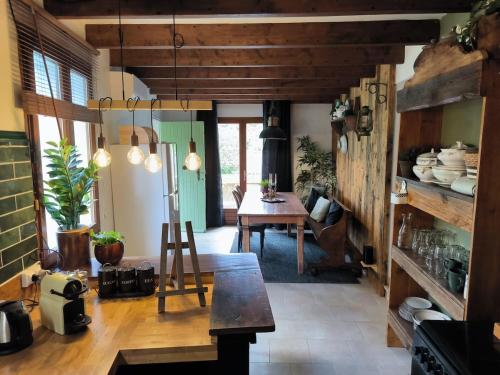 une cuisine avec une table et une salle à manger dans l'établissement Gîtes à la ferme, Le Jardin Bleu, à Tulette