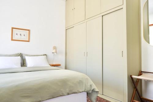 a bedroom with a white cabinet and a bed at Yoma in Amarinthos