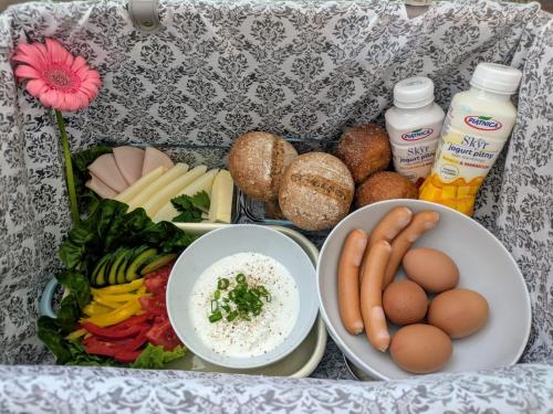 a tray of food with eggs vegetables and other foods at SB Apartment with Sauna in Kołobrzeg