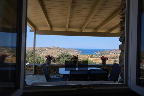 a table and chairs on a patio with a view at Petra Vista Retreats in Otzias