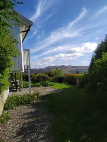 a house with a view of a yard at Spacious, quiet and cosy apartment near Kongeparken & Pulpit Rock in Ålgård