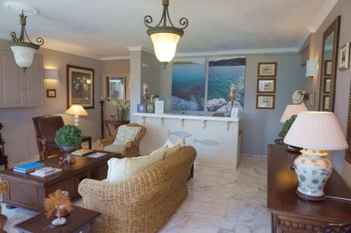 a living room with a couch and a table at Faros Suites (Adults Only) in Fiskardho